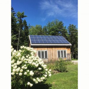 Solar panels and sustainable materials are used to achieve this LEED certified home and barn in Maine.