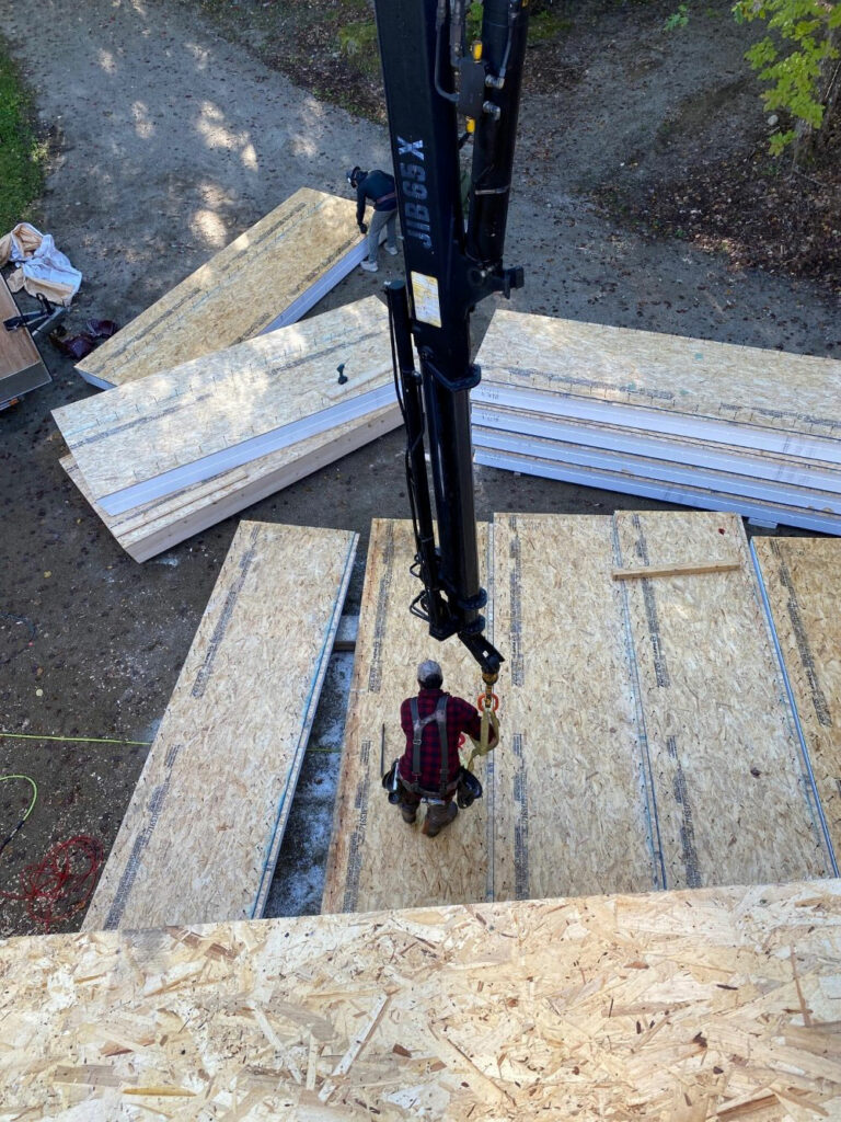 Staging panels of wood to be used in a timber frame custom home construction soon